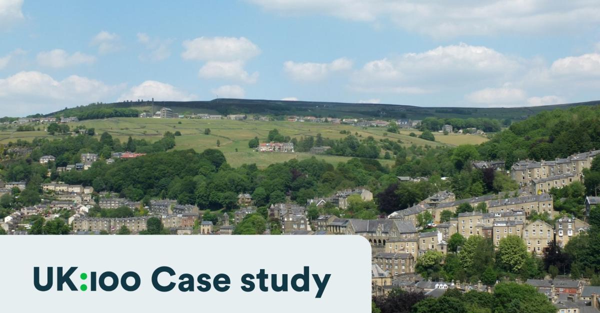 Panoramic view of streets and houses surrounded by trees and hills
